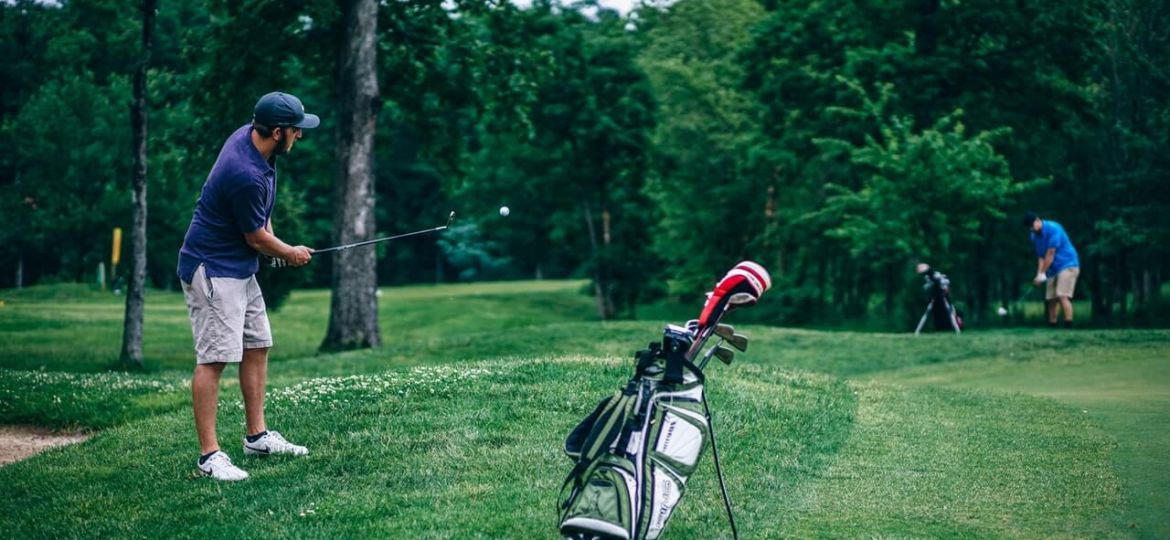 Man swinging a golf club in good form
